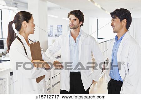 Doctors talking in hallway View Large Photo Image Stock Photo - Doctors talking in hallway. Fotosearch