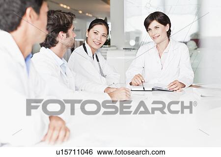 Doctors talking in meeting View Large Photo Image Stock Photograph - Doctors talking in meeting. Fotosearch