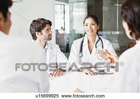 Doctors talking in meeting View Large Photo Image Stock Photography - Doctors talking in meeting. Fotosearch