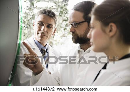 Doctors using glass panel View Large Photo Image Stock Image - Doctors using glass panel. Fotosearch