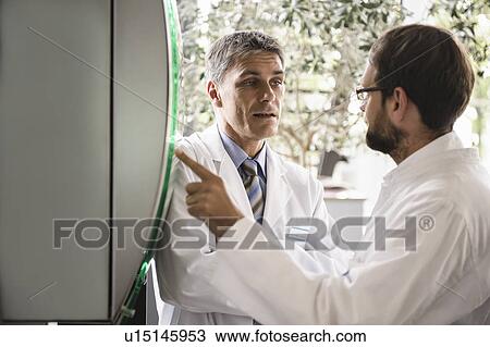 Doctors using glass panel View Large Photo Image Stock Image - Doctors using glass panel. Fotosearch