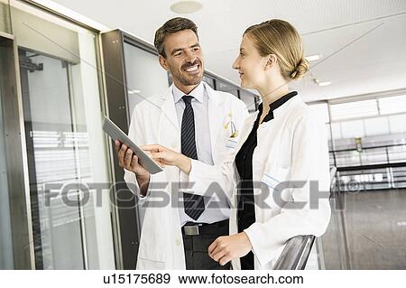 Stock Photo - Doctors using tablet computer. Fotosearch