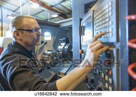 Engineer operating machinery in factory View Large Photo Image Stock Image - Engineer operating machinery in factory. Fotosearch