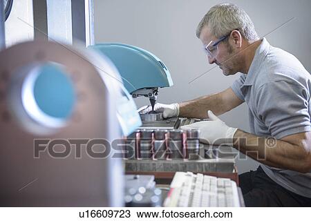 Engineer using polishing machinery View Large Photo Image Stock Image - Engineer using polishing machinery. Fotosearch