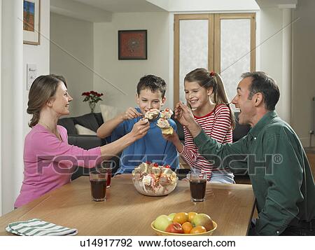 Family eating ice cream together View Large Photo Image Stock Image - Family eating ice cream together. Fotosearch
