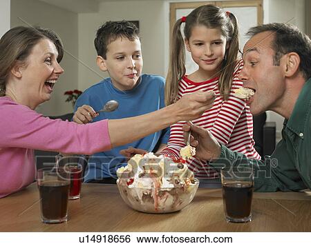 Family eating ice cream together View Large Photo Image Stock Photograph - Family eating ice cream together. Fotosearch