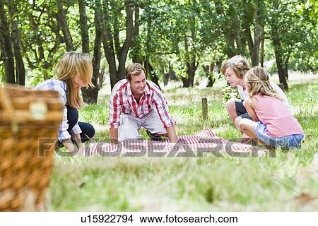 Picture - Family having picnic in park. Fotosearch