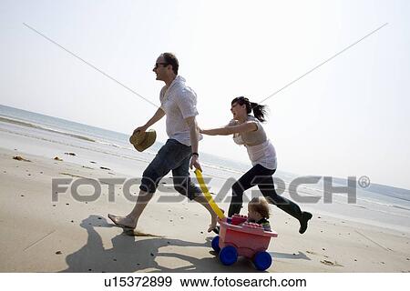 Family playing together on beach View Large Photo Image Stock Photo - Family playing together on beach. Fotosearch