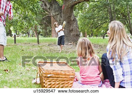 Family relaxing together in park View Large Photo Image Stock Photo - Family relaxing together in park. Fotosearch