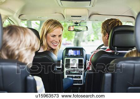 Stock Image - Family riding in car together. Fotosearch