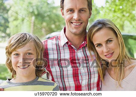 Family smiling together by car View Large Photo Image Stock Image - Family smiling together by car. Fotosearch