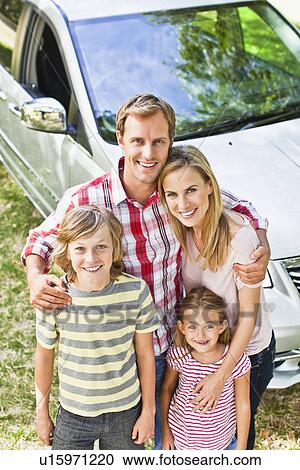 Family smiling together by car View Large Photo Image Stock Image - Family smiling together by car. Fotosearch