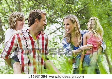 Family walking together in park View Large Photo Image Picture - Family walking together in park. Fotosearch