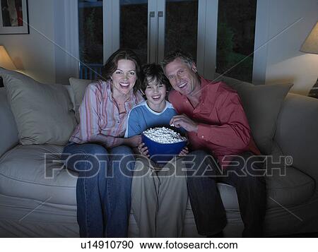Family watching movie together View Large Photo Image Stock Image - Family watching movie together. Fotosearch