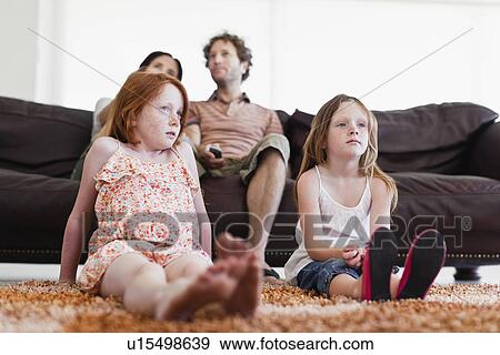 Family watching television together View Large Photo Image Stock Photo - Family watching television together. Fotosearch