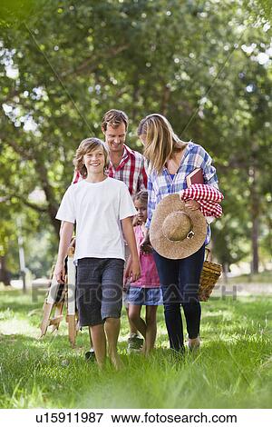 Family with picnic basket in park View Large Photo Image Stock Photo - Family with picnic basket in park. Fotosearch