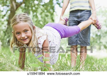 Father and daughter playing in park View Large Photo Image Picture - Father and daughter playing in park. Fotosearch