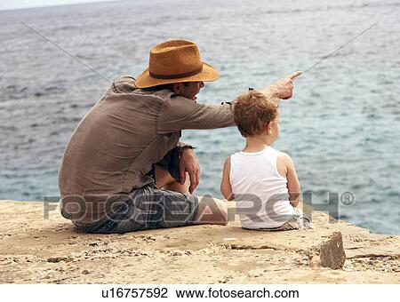 Father and son overlooking ocean View Large Photo Image Stock Image - Father and son overlooking ocean. Fotosearch