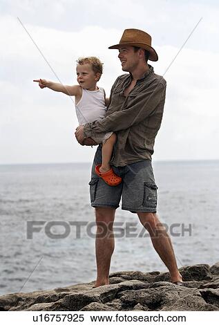 Father and son overlooking ocean View Large Photo Image Stock Photography - Father and son overlooking ocean. Fotosearch