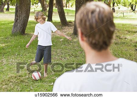 Father and son playing in park View Large Photo Image Stock Photograph - Father and son playing in park. Fotosearch