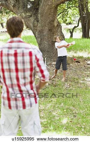 Father and son playing in park View Large Photo Image Stock Photography - Father and son playing in park. Fotosearch