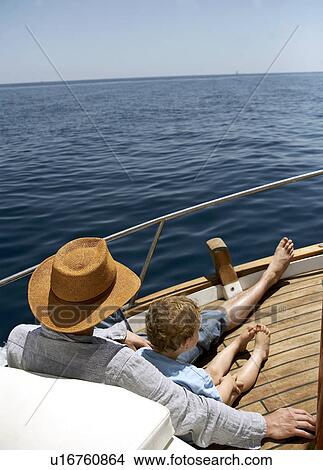 Picture - Father and son relaxing on boat. Fotosearch