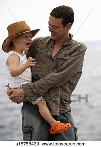 Father holding son outdoors View Large Photo Image Stock Photo - Father holding son outdoors. Fotosearch