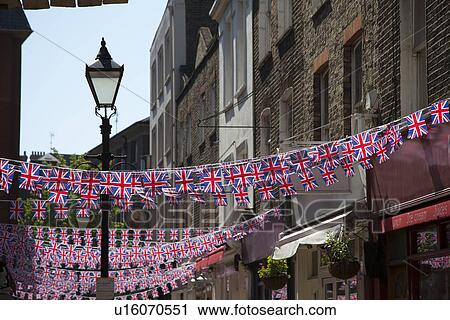 Flags hanging from city buildings View Large Photo Image Stock Image - Flags hanging from city buildings. Fotosearch