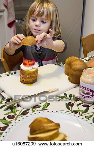 Girl making layer cake View Large Photo Image Stock Photo - Girl making layer cake. Fotosearch