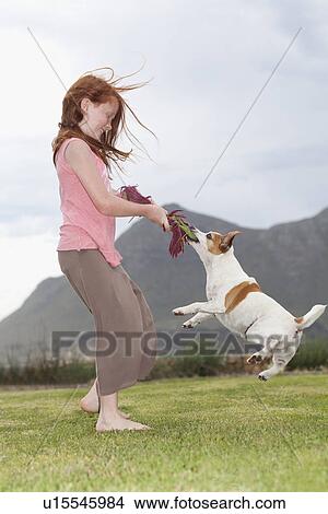Girl playing with dog in grass View Large Photo Image Picture - Girl playing with dog in grass. Fotosearch