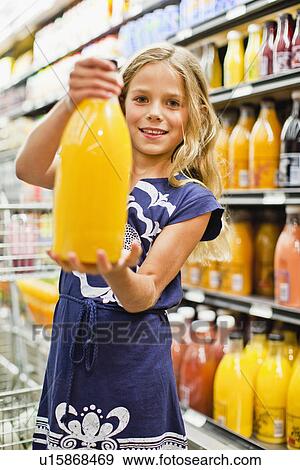 Stock Photo - Girl shopping in grocery store. Fotosearch