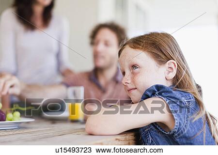 Girl sitting at breakfast table View Large Photo Image Stock Image - Girl sitting at breakfast table. Fotosearch