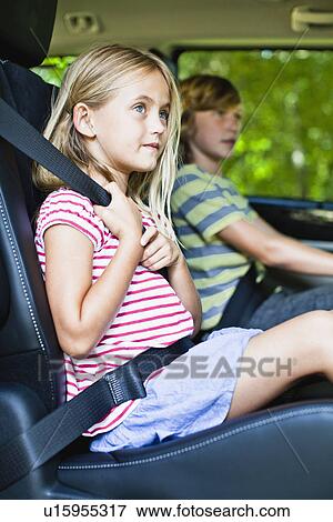 Girl sitting in car booster seat View Large Photo Image Stock Photo - Girl sitting in car booster seat. Fotosearch