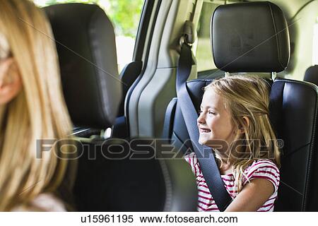 Girl smiling in backseat of car View Large Photo Image Stock Photography - Girl smiling in backseat of car. Fotosearch