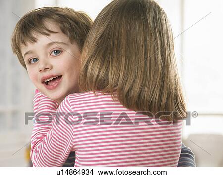 Girl whispering in boys ear View Large Photo Image Picture - Girl whispering in boys ear. Fotosearch