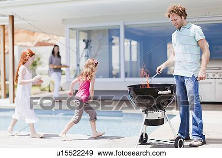 Girls around pool as father grills View Large Photo Image Stock Photo - Girls around pool as father grills. Fotosearch