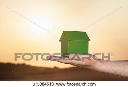 Hand holding model house outdoors View Large Photo Image Stock Image - Hand holding model house outdoors. Fotosearch