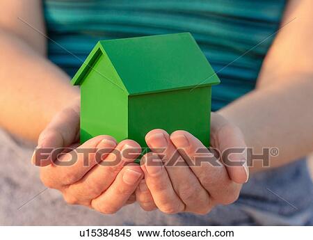Stock Photography - Hands holding model house outdoors. Fotosearch
