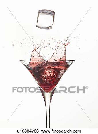 Ice cube splashing in cocktail glass View Large Photo Image Stock Photograph - Ice cube splashing in cocktail glass. Fotosearch