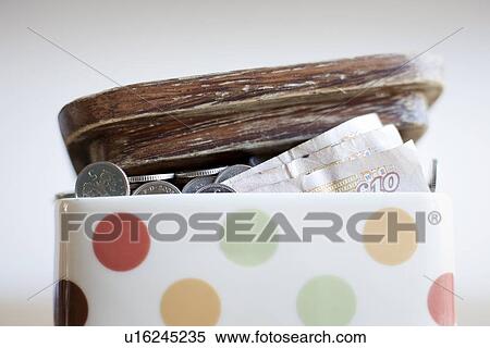 Jar full of money on desk View Large Photo Image Stock Photography - Jar full of money on desk. Fotosearch