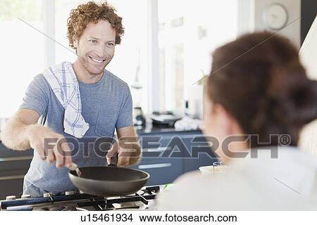 Man cooking for girlfriend in kitchen View Large Photo Image Picture - Man cooking for girlfriend in kitchen. Fotosearch