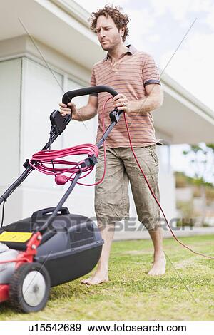 Man mowing green lawn View Large Photo Image Stock Photo - Man mowing green lawn. Fotosearch