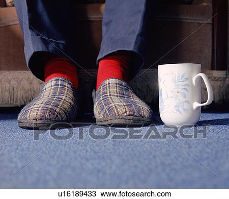 Mans feet in slippers with mug of tea View Large Photo Image Stock Image - Mans feet in slippers with mug of tea. Fotosearch
