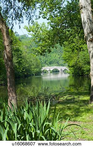 Stock Photo - Medieval bridge on rural river, Tarn, France. Fotosearch