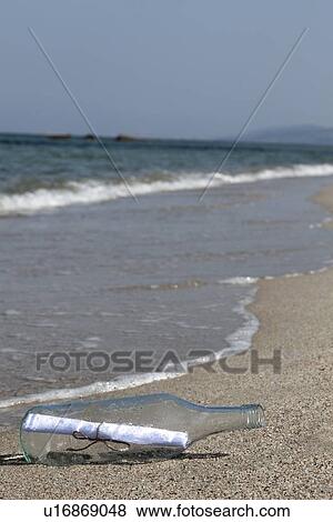 Message in bottle washed up on beach View Large Photo Image Stock Photo - Message in bottle washed up on beach. Fotosearch