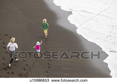 Mother and children walking on beach View Large Photo Image Stock Image - Mother and children walking on beach. Fotosearch