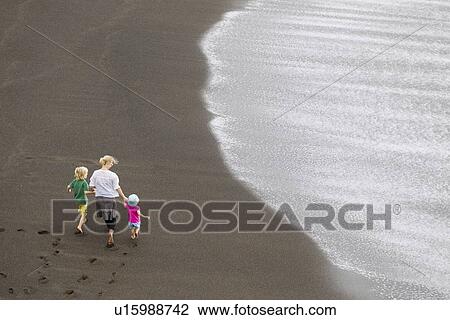 Mother and children walking on beach View Large Photo Image Stock Image - Mother and children walking on beach. Fotosearch