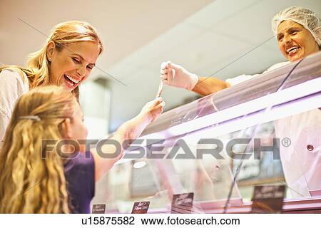 Mother and daughter at butcher counter View Large Photo Image Stock Image - Mother and daughter at butcher counter. Fotosearch