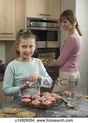 Mother and daughter baking together View Large Photo Image Picture - Mother and daughter baking together. Fotosearch