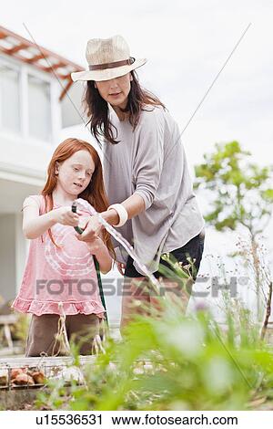 Mother and daughter gardening View Large Photo Image Stock Image - Mother and daughter gardening. Fotosearch